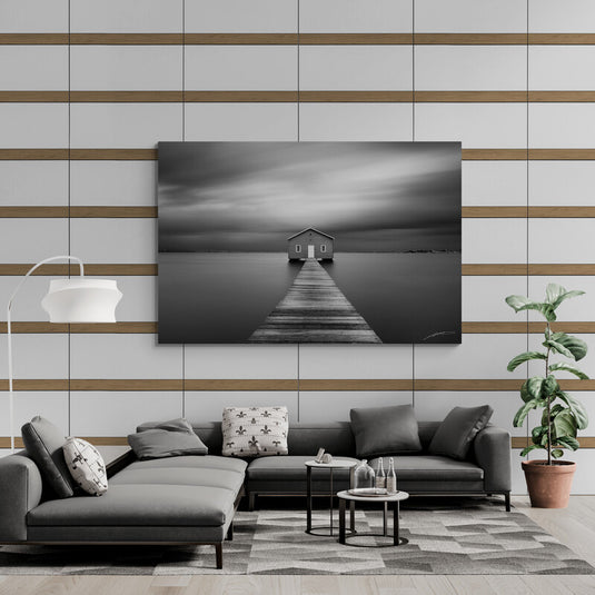 Fotografía en blanco y negro de una casa al final de un muelle en aguas tranquilas