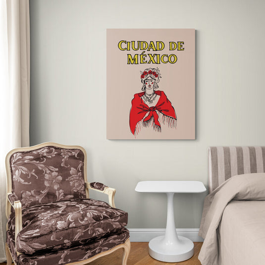 Cuadro decorativo con fondo rosa palo, título 'Ciudad de México' en amarillo con bordes negros y silueta minimalista de Frida en negro con detalles rojos en cabello, collares y chal