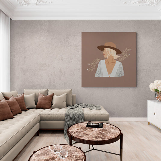 Cuadro decorativo con fondo café nude, silueta de mujer en blusa blanca abertura V, flores laterales y sombrero café