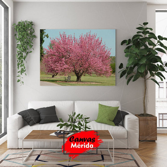 Cuadro decorativo de paisaje con césped y árbol de hojas rosadas.