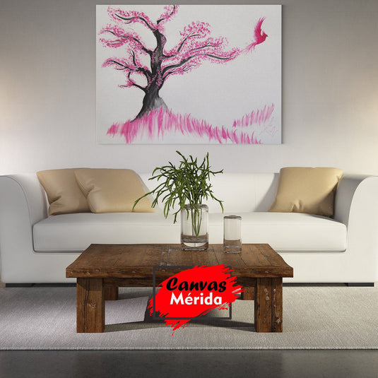 Cuadro decorativo con fondo blanco, árbol de tronco oscuro, hojas rosas y ave fénix emergiendo.