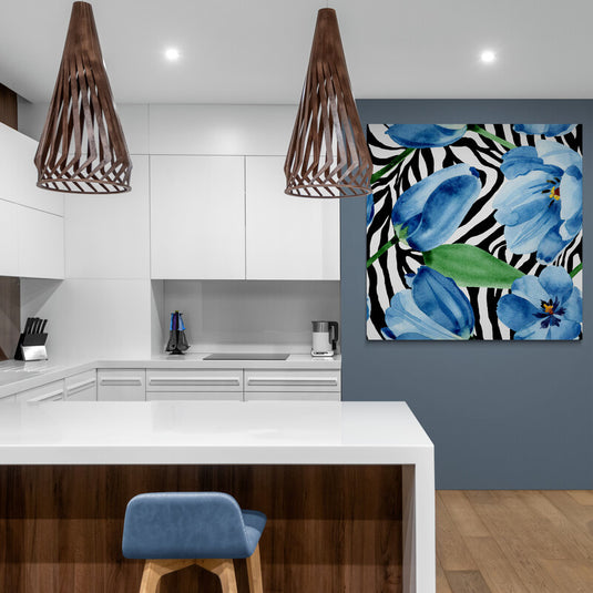 Cuadro decorativo con diseño de rayas tipo cebra en blanco y negro, complementado con flores azules y hojas verdes.