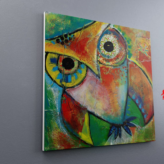 Cuadro decorativo con fondo en tonos verdes, amarillo, naranja y rojo, destacando silueta de búho con toques azules