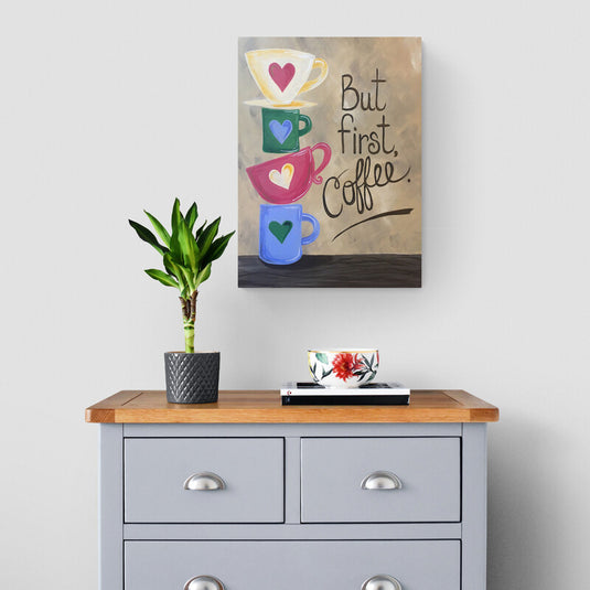 Cuadro decorativo con frase "But first, Coffee" y tazas de colores apiladas con corazones, diseño alegre y moderno ideal para decoración de cocina, cafetería o espacios creativos y acogedores.