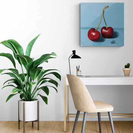 Cuadro minimalista de dos cerezas rojas sobre fondo azul.