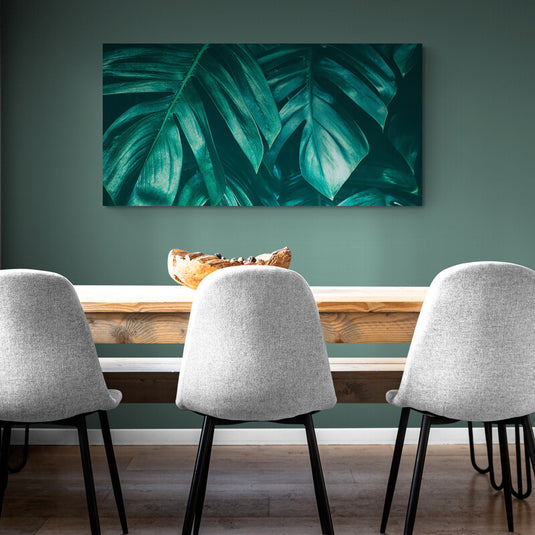 Cuadro decorativo con hojas verdes brillantes sobre fondo verde esmeralda