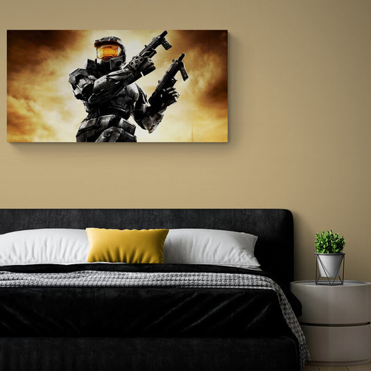 El cuadro muestra a un Spartan de Halo con dos armas, en una pose dinámica, fondo de cielo dorado/anaranjado.