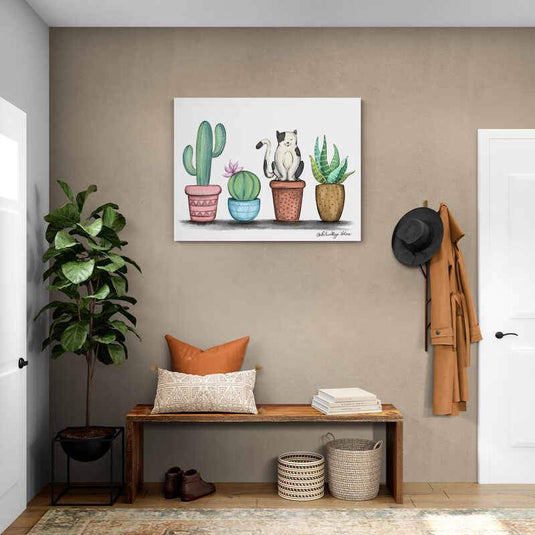Gato blanco y negro entre macetas de cactus en fondo blanco