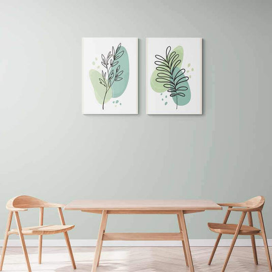 Set de cuadros decorativos con fondo blanco, manchas en tonos verde y turquesa, y silueta negra de rama delicada