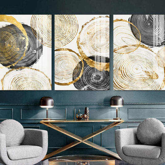Set de cuadros decorativos con fondo blanco: sellos de tronco en tonos negro, dorado y amarillo en variados tamaños."