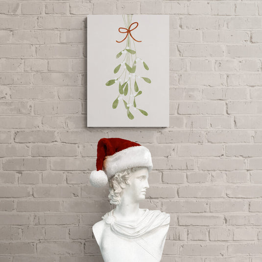 Muérdago estilizado con acuarela y cinta roja en composición minimalista que realza la tradición navideña y la delicadeza de la estación