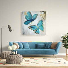 Pintura de mariposas azules con detalles dorados en fondo texturizado