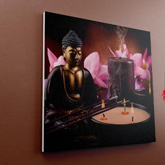 Composición artística con estatua de Buda, flores de loto y velas para meditación.