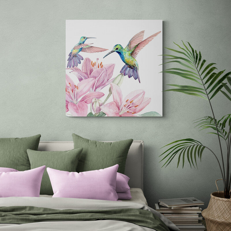 Dos colibríes multicolores en tonos verde, azul, rosa y morado rodeando flores rosadas sobre fondo blanco