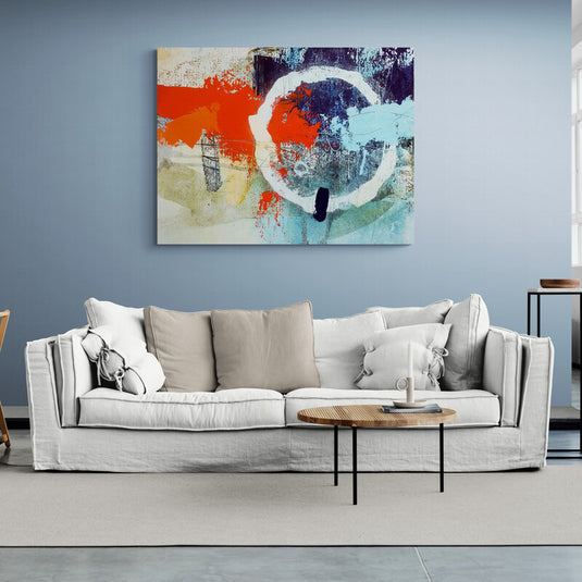 Cuadro abstracto con formas circulares y tonos vibrantes de naranja, azul y blanco