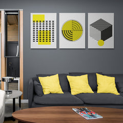 Set de cuadros decorativos en fondo blanco: rectángulo amarillo con semicírculos negros, diseño de radar amarillo y negro, y cubo con líneas contrastantes y círculo amarillo.
