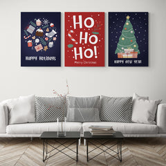 Set de cuadros navideños: 'Happy Holidays' en azul con motivos festivos, 'HO HO HO' en rojo con diseño navideño, y árbol iluminado en azul con 'Happy New Year'