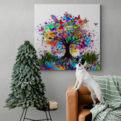 Cuadro decorativo de árbol con tronco café y ramas en múltiples colores, adornado con flores, mariposas, plumas y un pequeño pájaro sobre fondo blanco